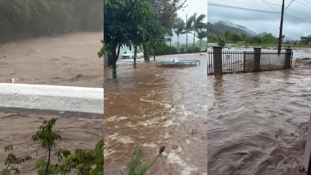 Rio cheio e água invadindo quintais e rua em Timbé do Sul durante temporal